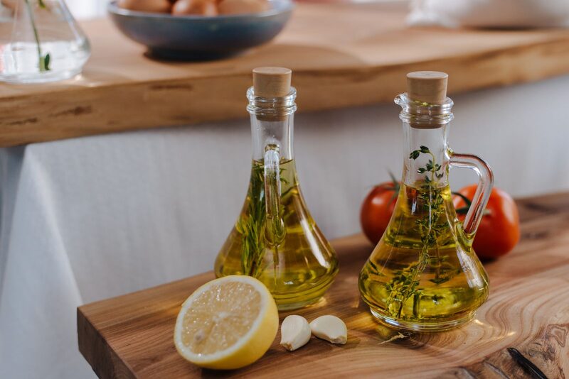 Két üveg fűszeres növényi olaj egy konyhai munkalapon